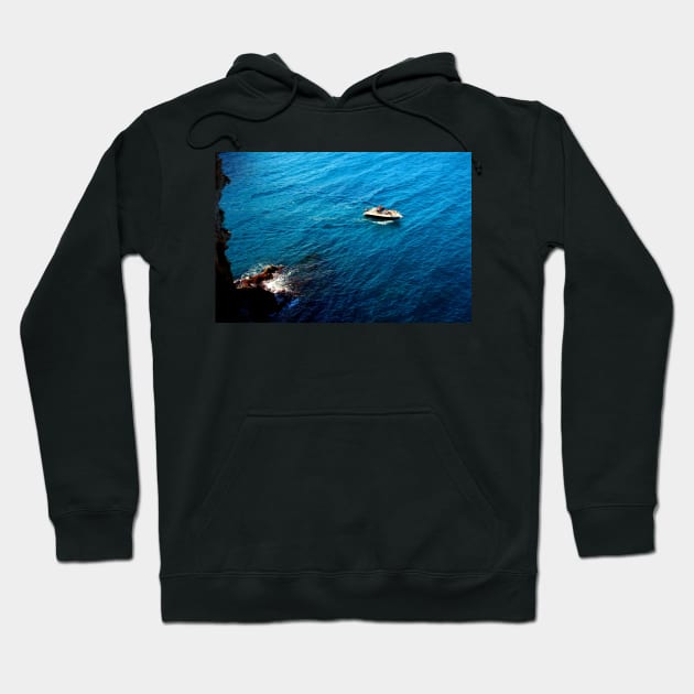 View from a high rocky shore of Polignano a Mare at a boat in the Adriatic sea Hoodie by KristinaDrozd